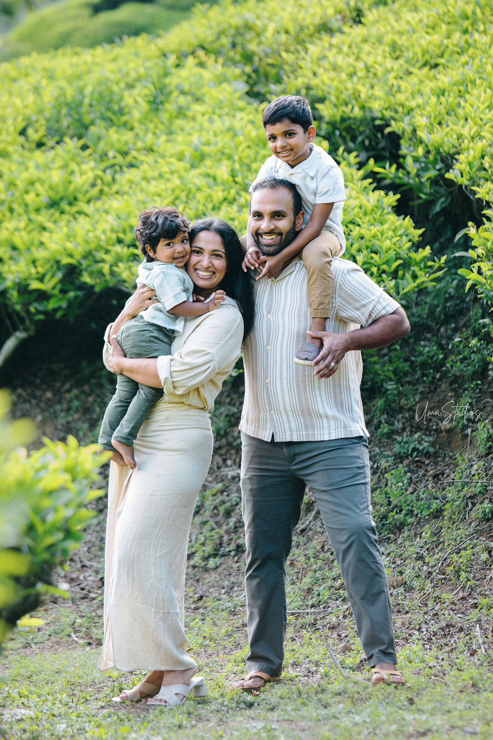 "Happy outdoor family photoshoot in Munnar tea garden with natural greenery"