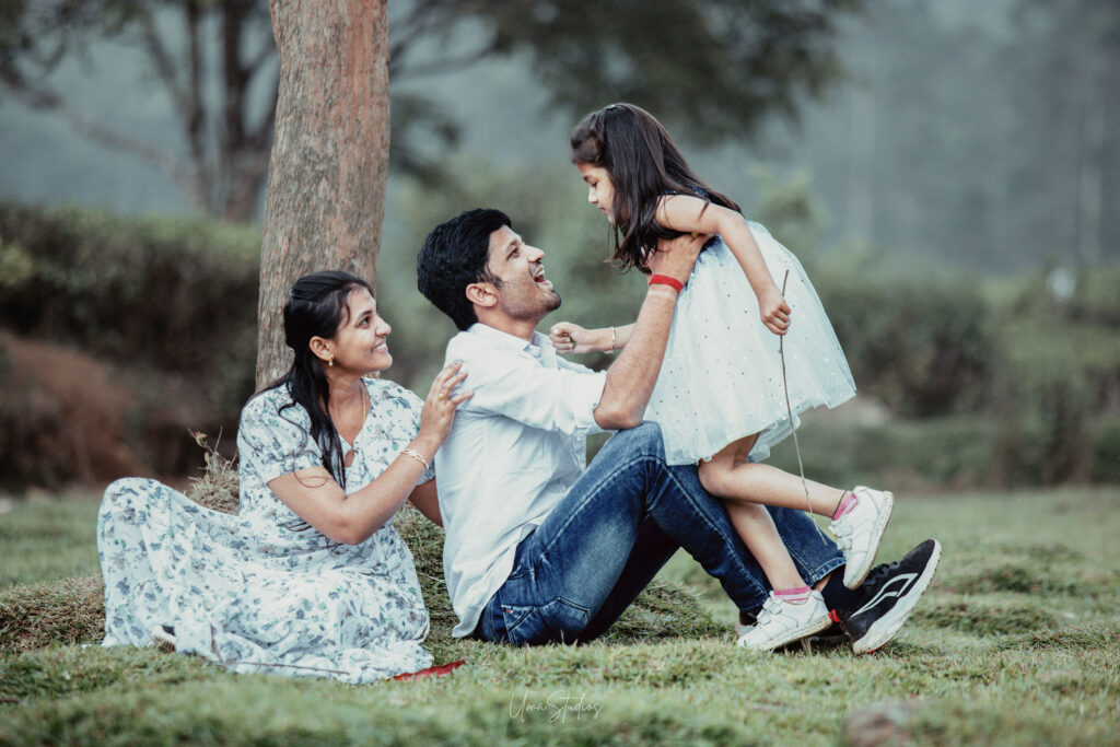 "Candid outdoor family shoot with dramatic Munnar valley background"
